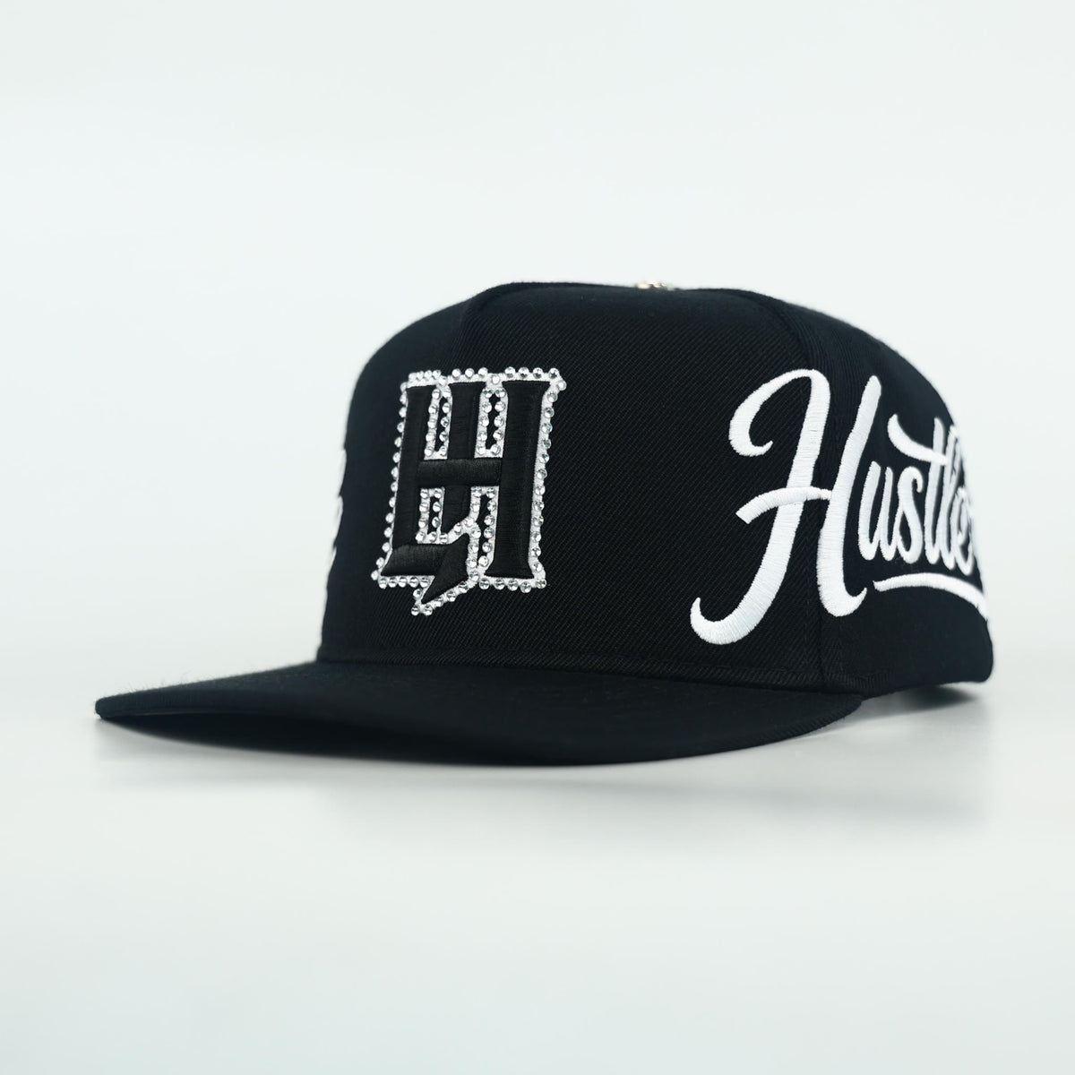 Life Hustlers Cap - black snapback with white "Hustler" script and logo